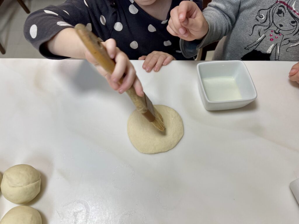 my Daughter Jo brushing oil onto the boa bun before it gets folded.