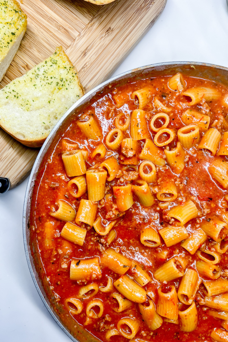 finished One-Pot Rigatoni Ragu next to garlic bread